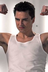 John Barrowman flexing his muscles.