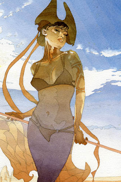 A woman in a tan bikini with an elaborate arm tattoo and staff stands in the desert.