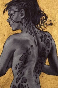 A nude woman stands, revealing leopard-like spots on her face, neck and back.