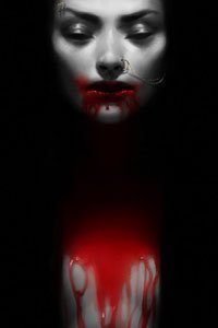 A pale woman is clothed in darkness, her naked chest covered in bright red blood.